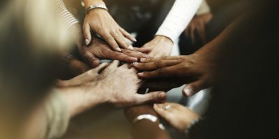 Closeup of diverse people joining their hands